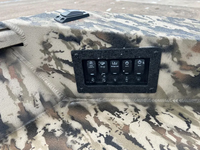 Slide: The Image of Control panel on 2025 Excel 1751 River Warrior boat with camouflage design. - 16