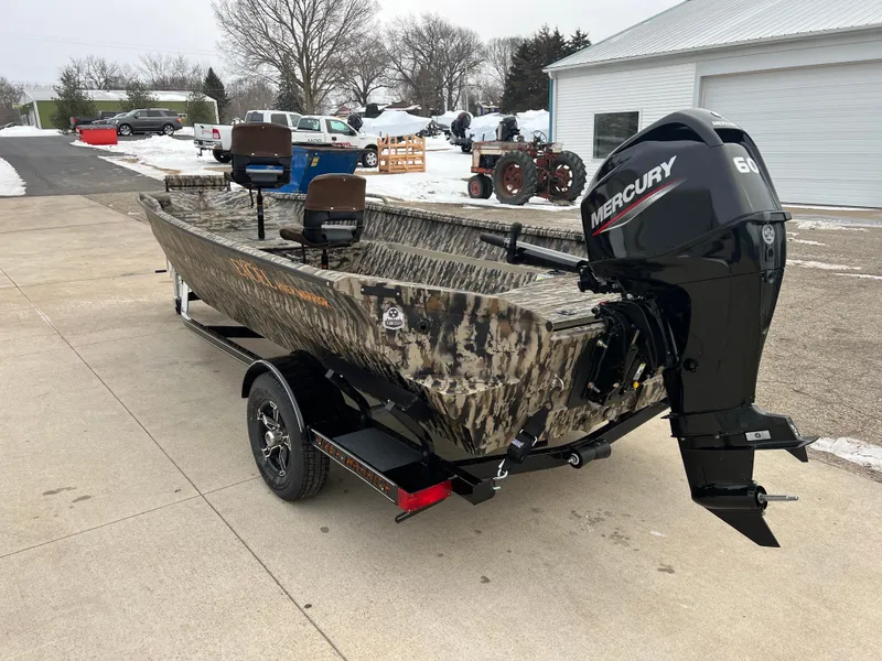 Slide: The Image of 2025 Excel 1751 River Warrior boat with Mercury engine on trailer, parked outdoors. - 4