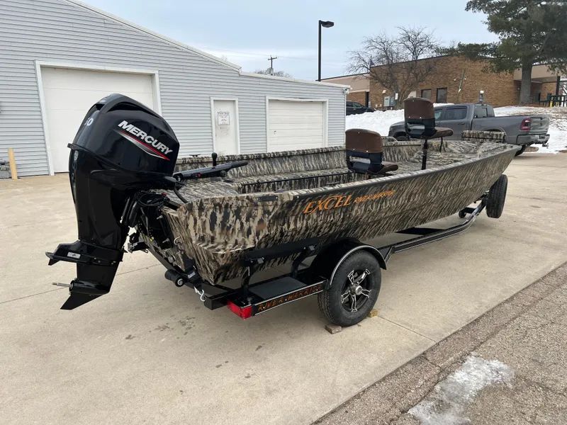 Slide: The Image of 2025 Excel 1751 River Warrior boat with Mercury engine, parked outdoors. - 6