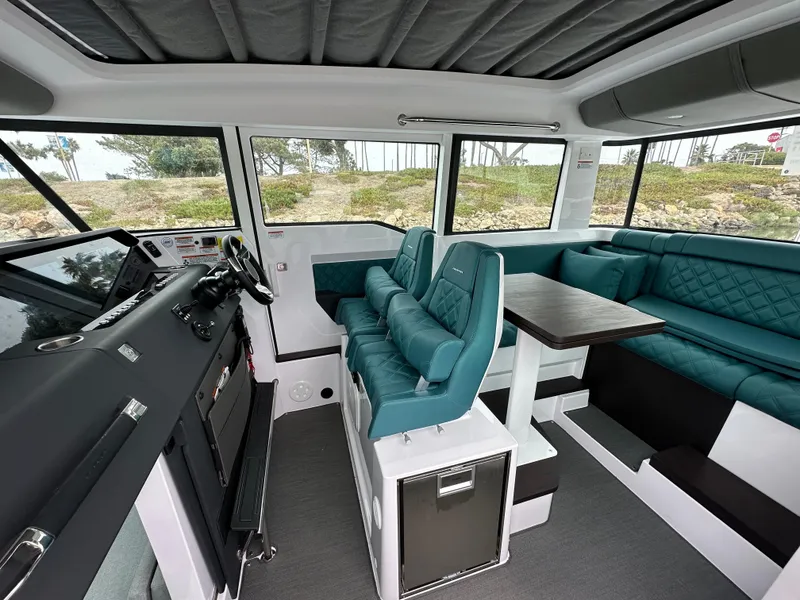 Slide: The Image of 2023 Axopar 37 XC Crosscabin interior with teal seating and modern design. - 2