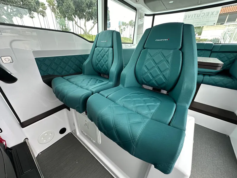 Slide: The Image of Luxurious interior seating of 2023 Axopar 37 XC Crosscabin with teal quilted upholstery. - 3