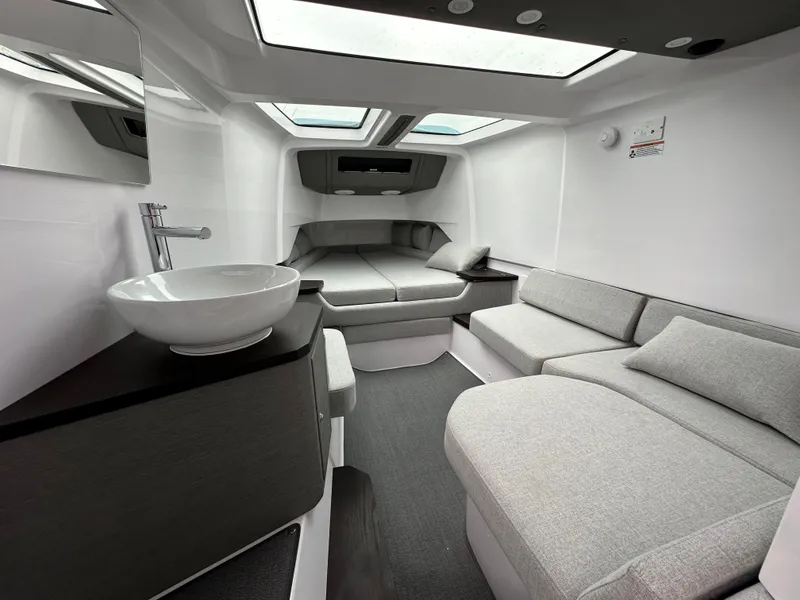 Slide: The Image of Luxurious interior of 2023 Axopar 37 XC Crosscabin with modern seating and skylights. - 5