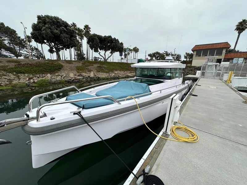 Slide: The Image of 2023 Axopar 37 XC Crosscabin docked, featuring sleek design and modern amenities. - 7