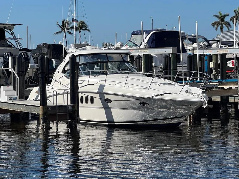 Slide: The Image of 2008 Sea Ray 38 Sundancer yacht docked at marina with palm trees in background. - 1