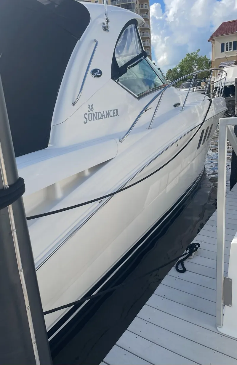 Slide: The Image of 2008 Sea Ray 38 Sundancer yacht docked at marina under blue sky. - 10