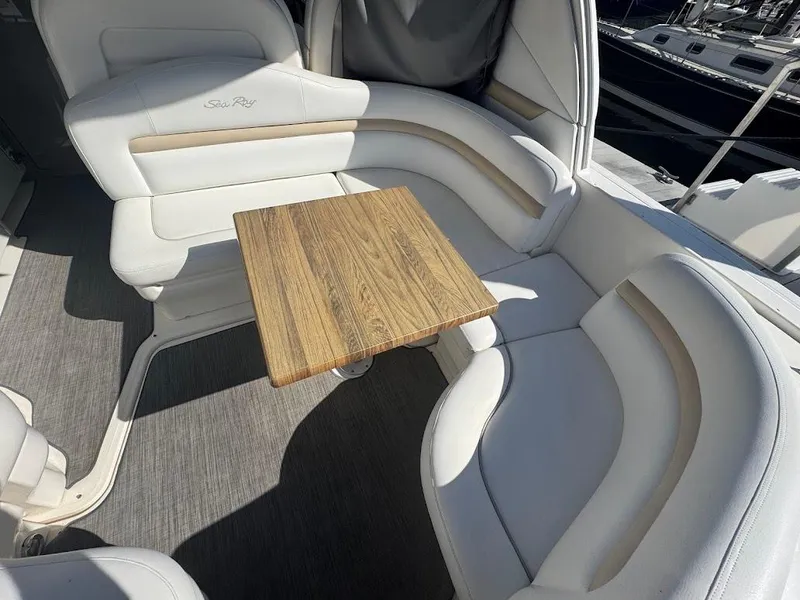 Slide: The Image of 2008 Sea Ray 38 Sundancer interior with white seating and wooden table. - 17