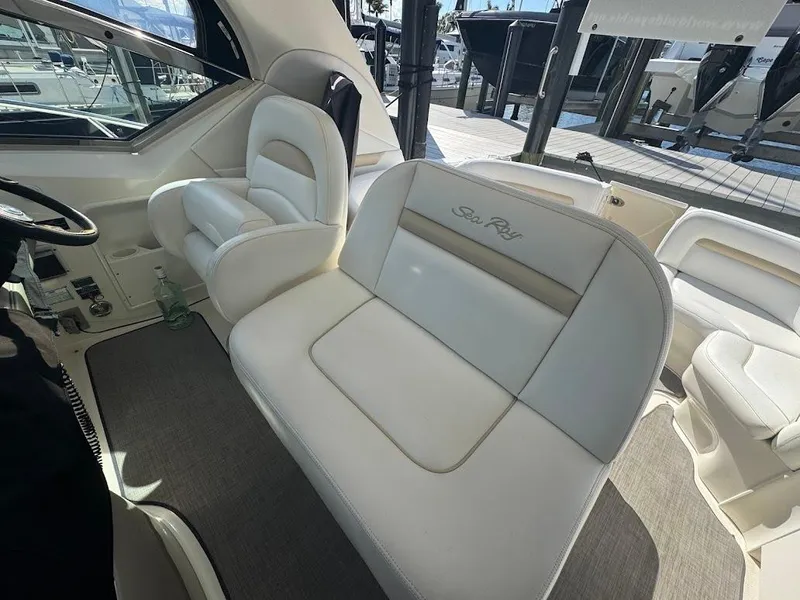 Slide: The Image of 2008 Sea Ray 38 Sundancer interior with white leather seating and helm station. - 20