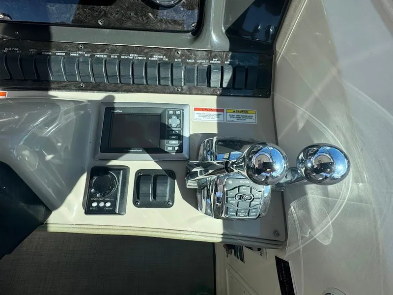 Slide: The Image of Control panel of a 2008 Sea Ray 38 Sundancer boat with chrome throttle levers. - 24