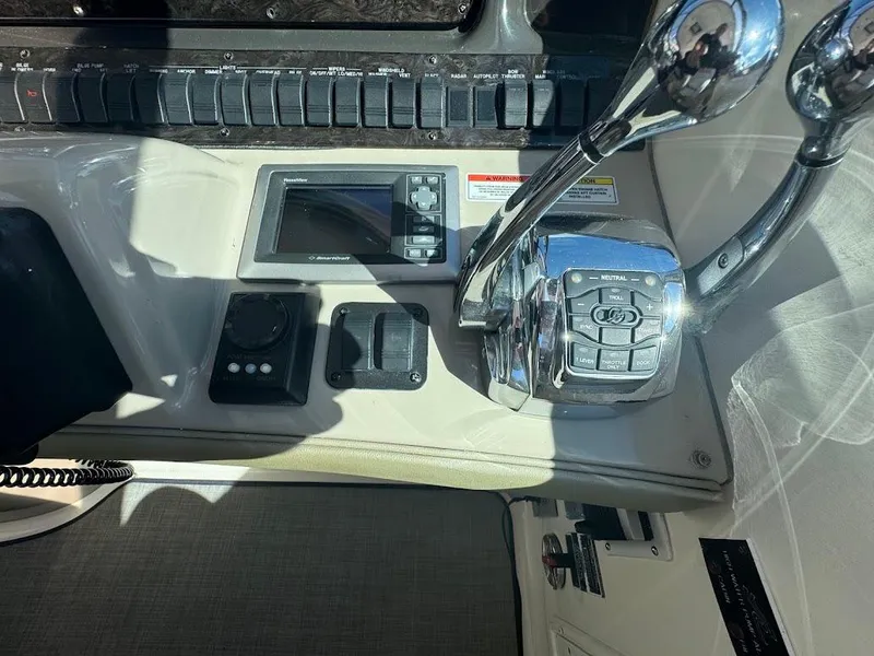 Slide: The Image of Control panel of 2008 Sea Ray 38 Sundancer boat with throttle and display. - 25