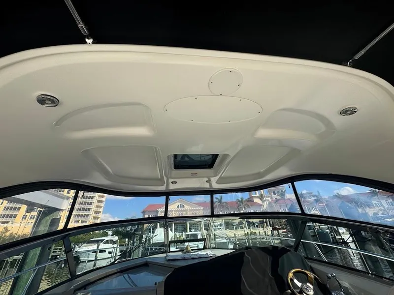 Slide: The Image of 2008 Sea Ray 38 Sundancer helm with marina view through windshield. - 26