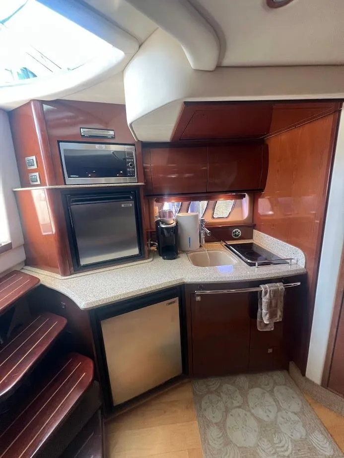 Slide: The Image of 2008 Sea Ray 38 Sundancer yacht kitchen with modern appliances and wood cabinetry. - 31