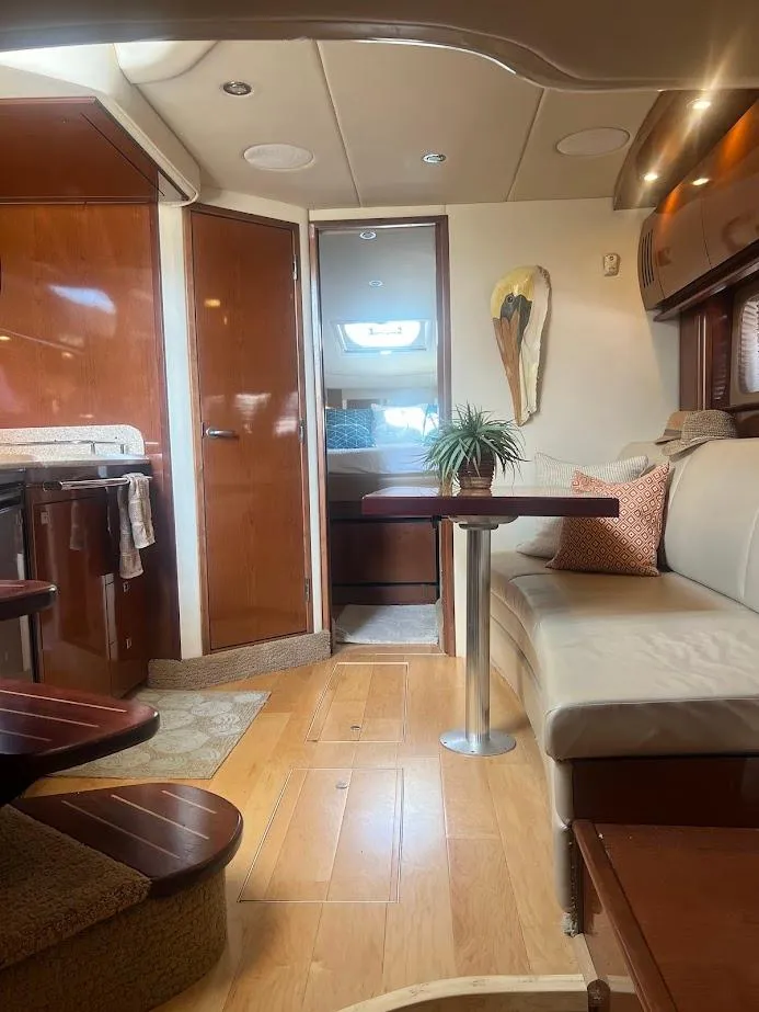 Slide: The Image of Interior of 2008 Sea Ray 38 Sundancer yacht with modern furnishings and wood accents. - 33