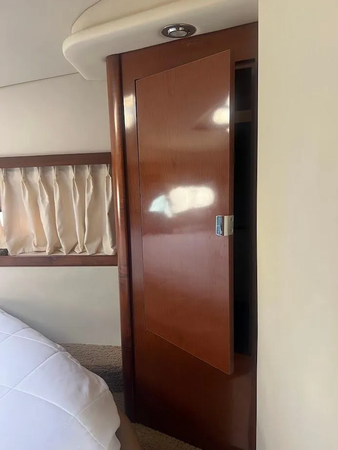 Slide: The Image of Interior of 2008 Sea Ray 38 Sundancer with wooden cabinet and curtain. - 35