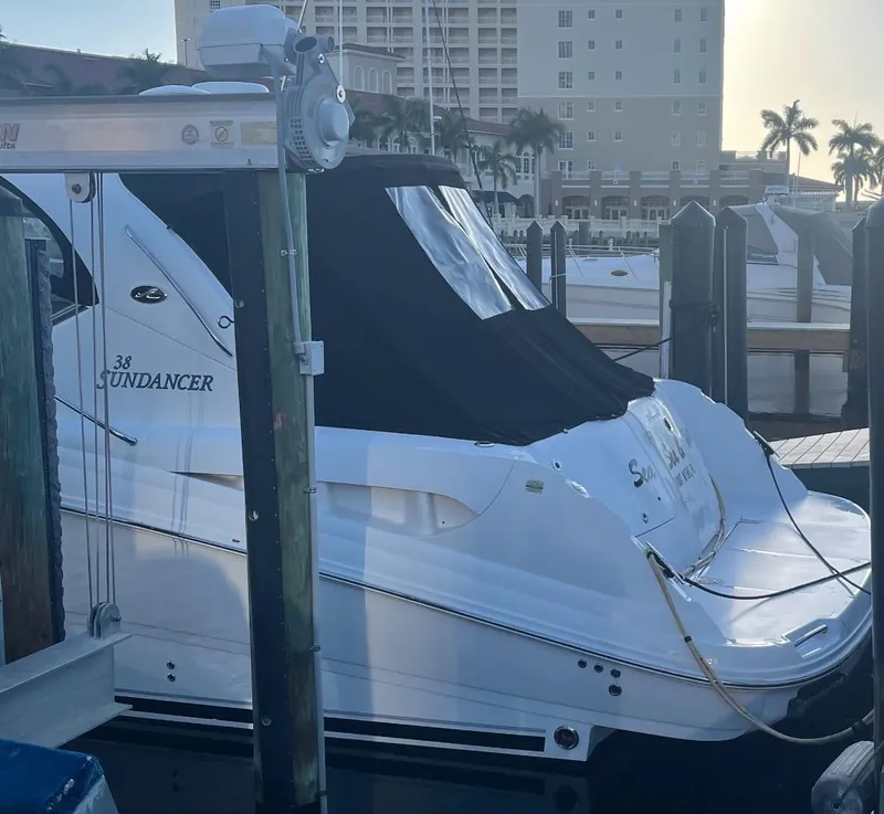 Slide: The Image of 2008 Sea Ray 38 Sundancer yacht docked at marina with buildings in background. - 4