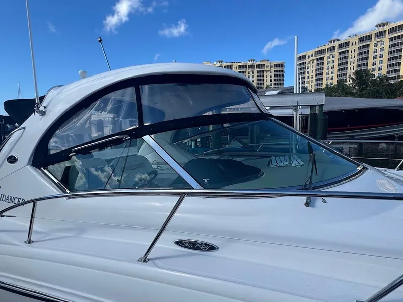 Slide: The Image of 2008 Sea Ray 38 Sundancer yacht docked, with clear blue sky and buildings in the background. - 41