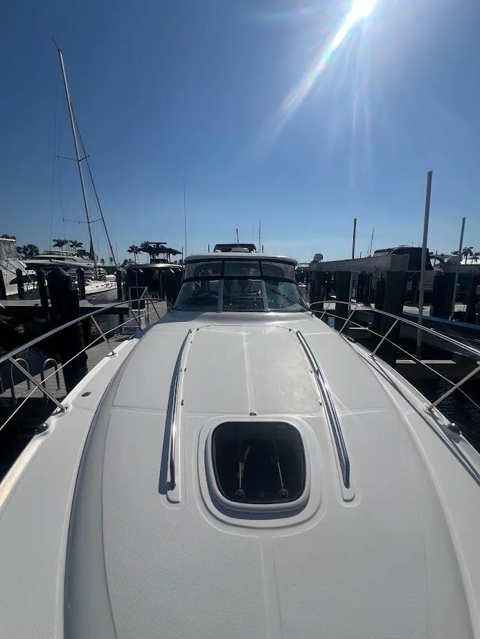 Slide: The Image of 2008 Sea Ray 38 Sundancer yacht docked under clear blue sky. - 42