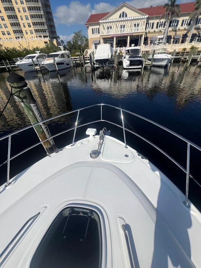 Slide: The Image of 2008 Sea Ray 38 Sundancer docked at marina with waterfront buildings. - 43