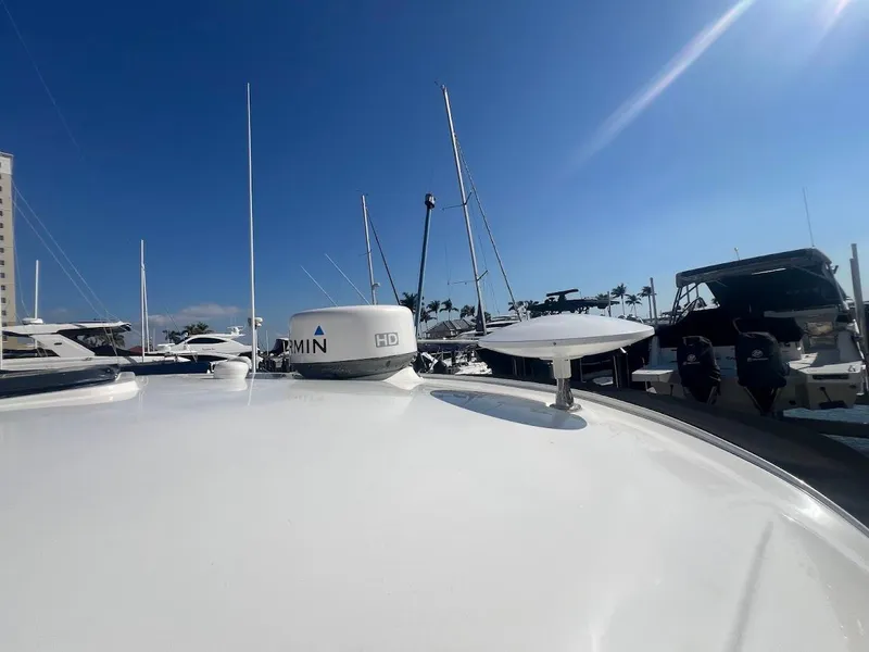 Slide: The Image of 2008 Sea Ray 38 Sundancer yacht docked under clear blue sky. - 44