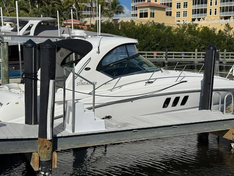 Slide: The Image of 2008 Sea Ray 38 Sundancer yacht docked at marina, surrounded by water and greenery. - 6