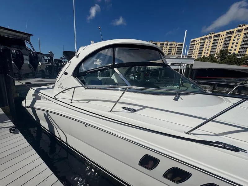 Slide: The Image of 2008 Sea Ray 38 Sundancer yacht docked at marina under clear blue sky. - 7
