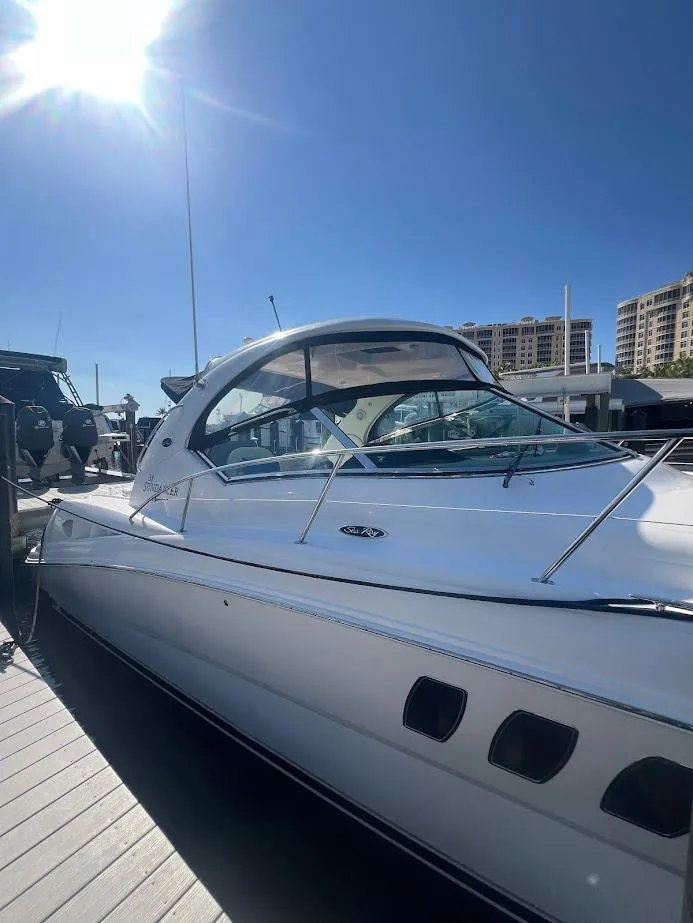 Slide: The Image of 2008 Sea Ray 38 Sundancer yacht docked under clear blue sky. - 9
