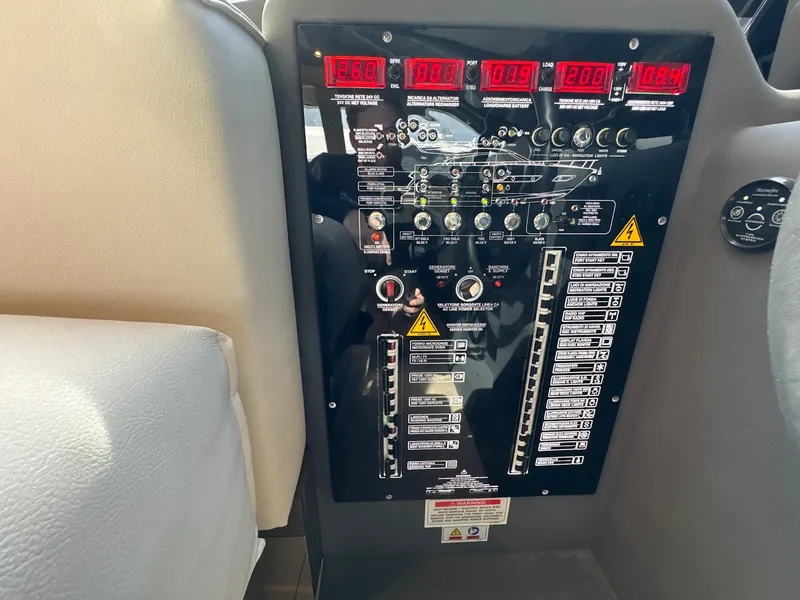 Slide: The Image of Control panel of a 2022 Ferretti Yachts 550, featuring digital displays and switches. - 10