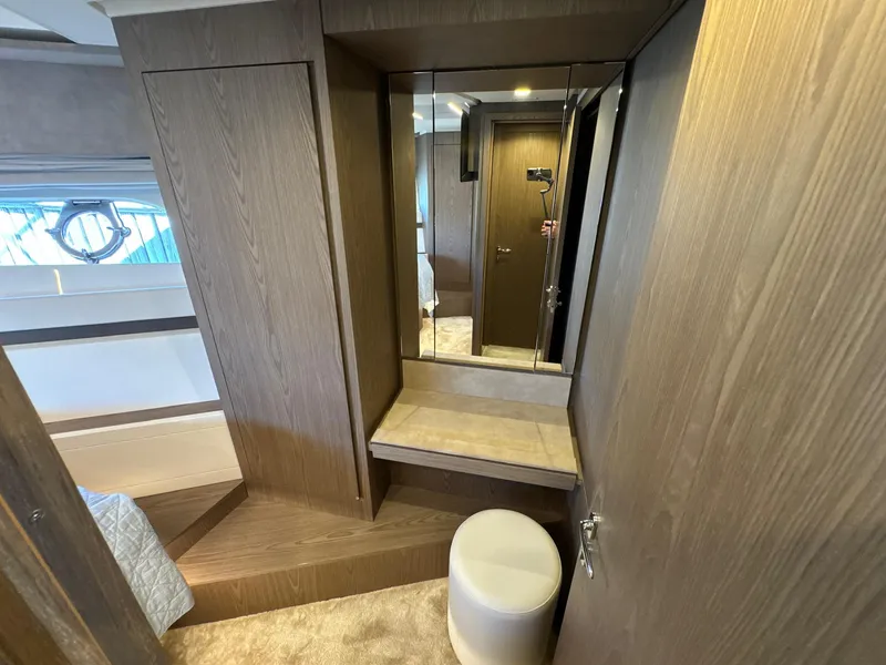 Slide: The Image of Interior of 2022 Ferretti Yachts 550, featuring a wooden vanity and mirror. - 22