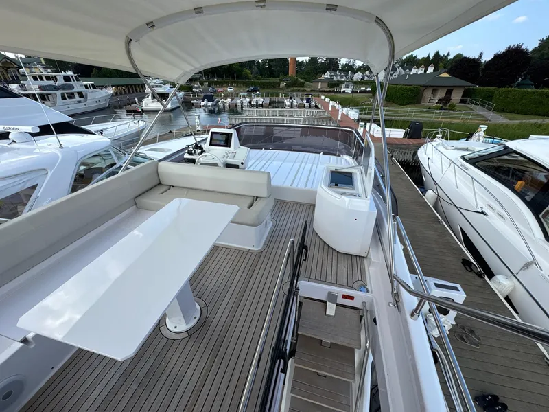 Slide: The Image of Luxurious 2022 Ferretti Yachts 550 flybridge with elegant seating and modern helm station. - 28