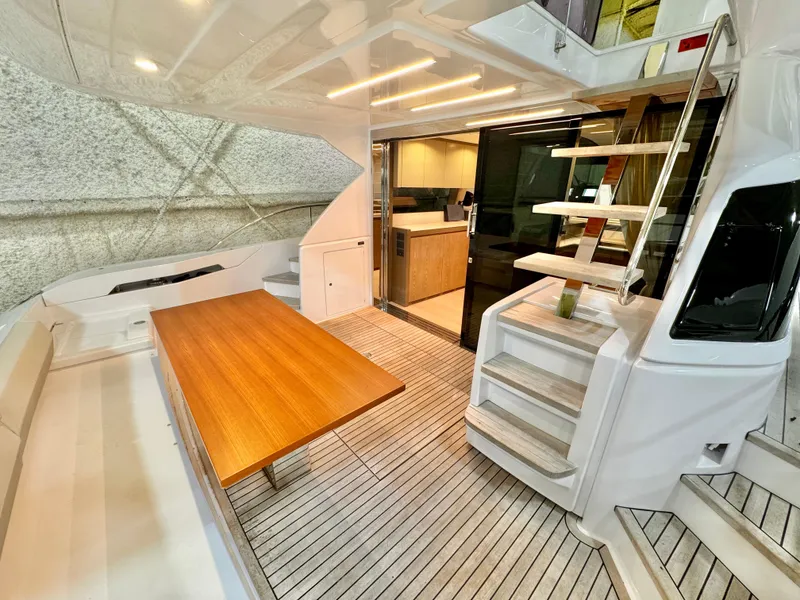 Slide: The Image of Luxurious 2022 Ferretti Yachts 550 interior with wooden table and modern design. - 80