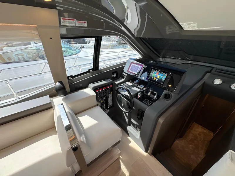Slide: The Image of Interior cockpit of 2022 Ferretti Yachts 550, featuring modern navigation equipment and luxurious seating. - 9