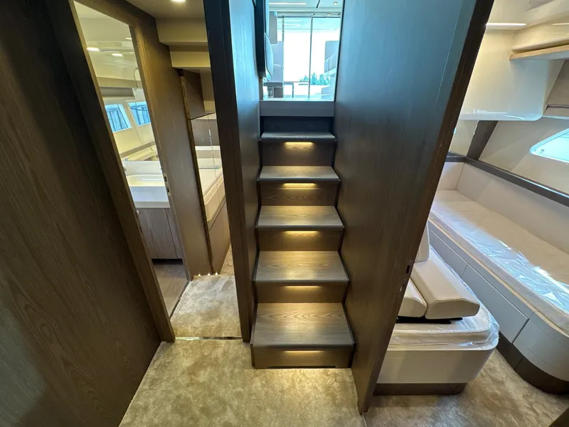 Slide: The Image of Interior of 2022 Ferretti Yachts 550, featuring elegant wooden stairs and modern design. - 13