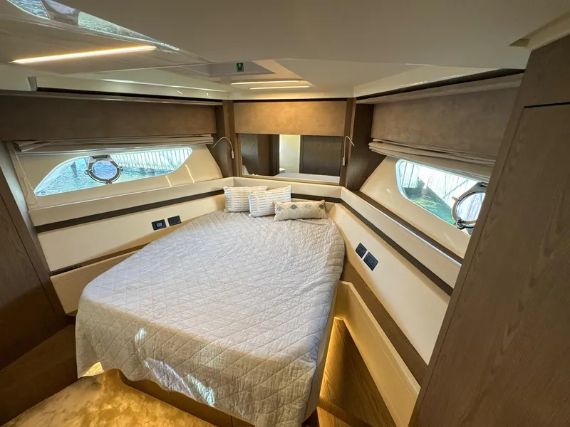 Slide: The Image of Luxurious bedroom interior of 2022 Ferretti Yachts 550 with elegant bedding and wood accents. - 23
