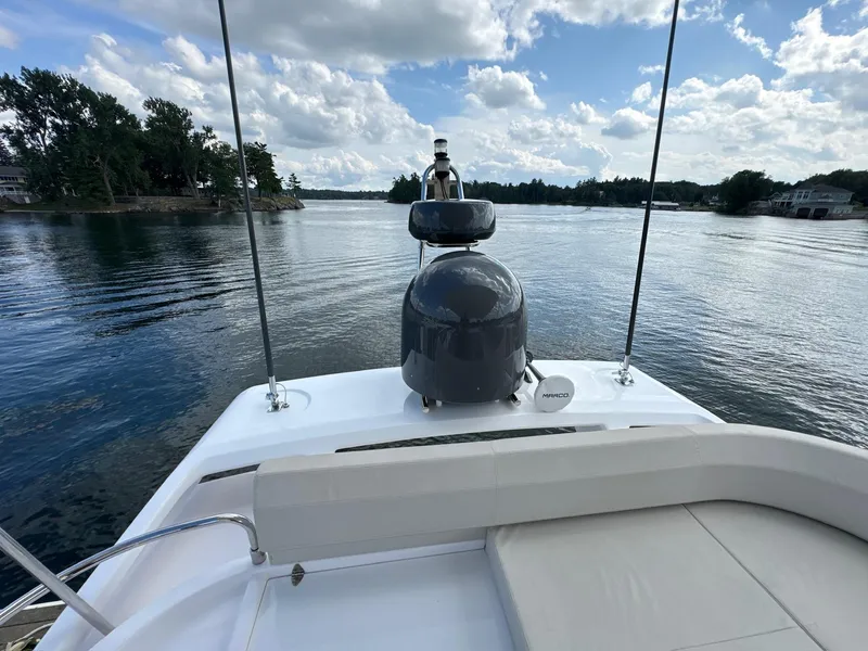 Slide: The Image of Ferretti Yachts 550, 2022 model, cruising on a serene lake under a partly cloudy sky. - 30