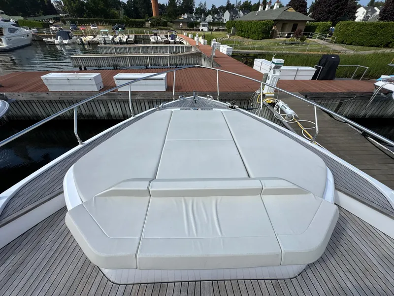 Slide: The Image of Luxury Ferretti Yachts 550, 2022 model, docked with spacious sunbathing area. - 34