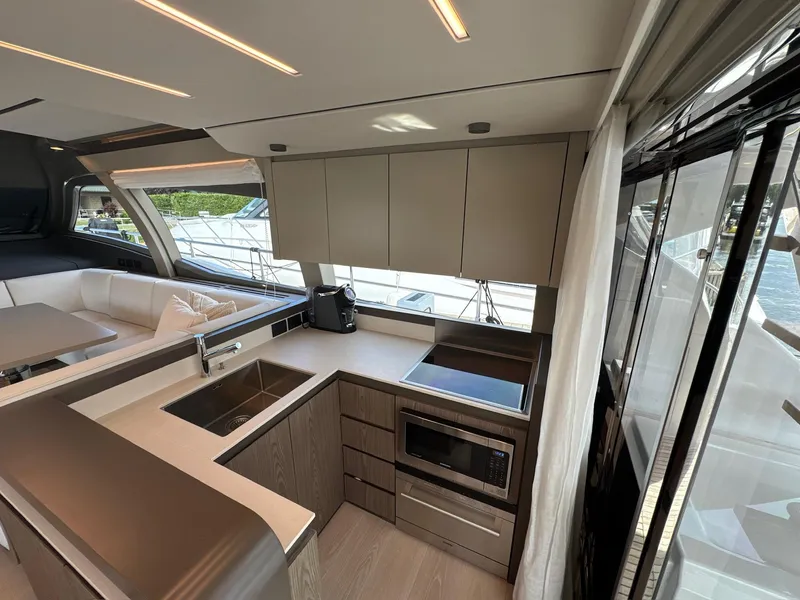 Slide: The Image of Modern kitchen interior of 2022 Ferretti Yachts 550, featuring sleek cabinetry and appliances. - 4