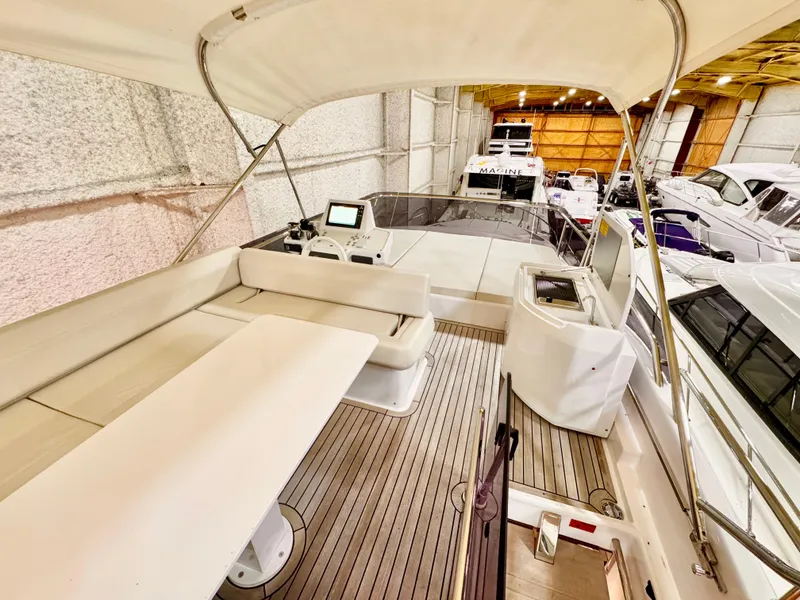 Slide: The Image of 2022 Ferretti Yachts 550 interior with seating and navigation equipment in a showroom. - 63