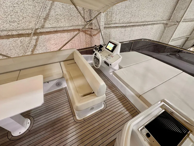 Slide: The Image of Luxurious 2022 Ferretti Yachts 550 interior with seating and navigation equipment. - 67