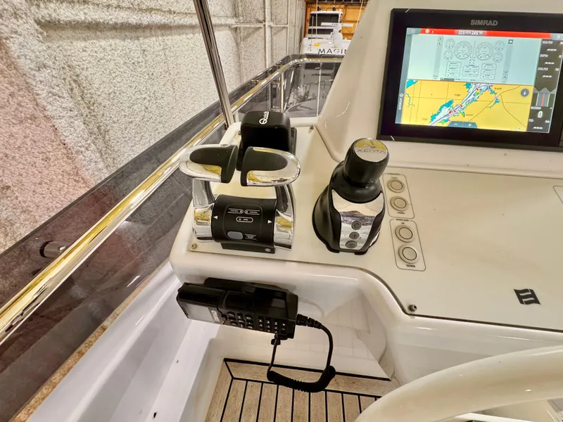 Slide: The Image of Cockpit controls of a 2022 Ferretti Yachts 550, featuring navigation screen and communication device. - 70