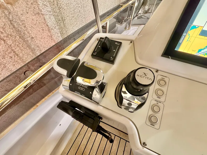 Slide: The Image of Control panel of 2022 Ferretti Yachts 550, featuring navigation and throttle controls. - 72