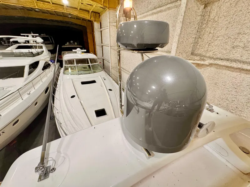 Slide: The Image of 2022 Ferretti Yachts 550 in a marina, surrounded by other luxury boats. - 75