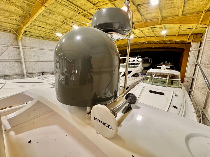 Slide: The Image of 2022 Ferretti Yachts 550 radar equipment in a boat storage facility. - 76