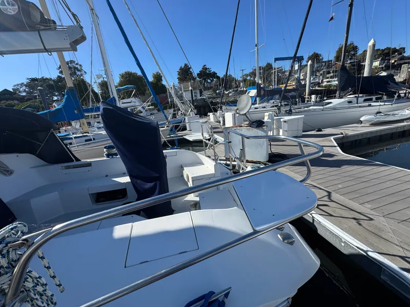 Slide: The Image of 2001 Catalina 42 MK II sailboat docked at a marina under clear blue skies. - 12
