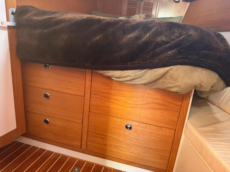Slide: The Image of Cozy cabin interior of 2001 Catalina 42 MK II with wooden drawers and bed. - 18