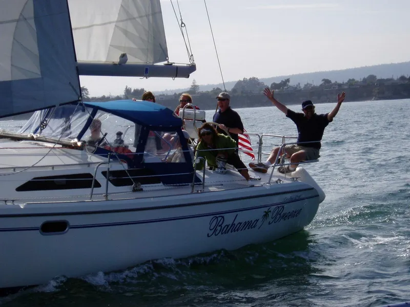 Slide: The Image of Sailing on a 2001 Catalina 42 MK II yacht named "Bahama Breeze" with passengers enjoying the sea. - 2