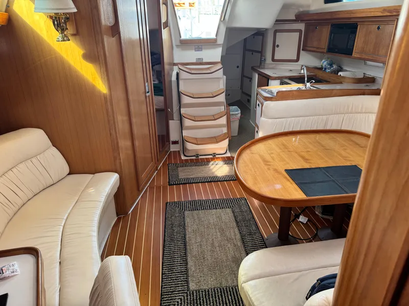 Slide: The Image of Interior of a 2001 Catalina 42 MK II sailboat with wood finishes and seating area. - 23