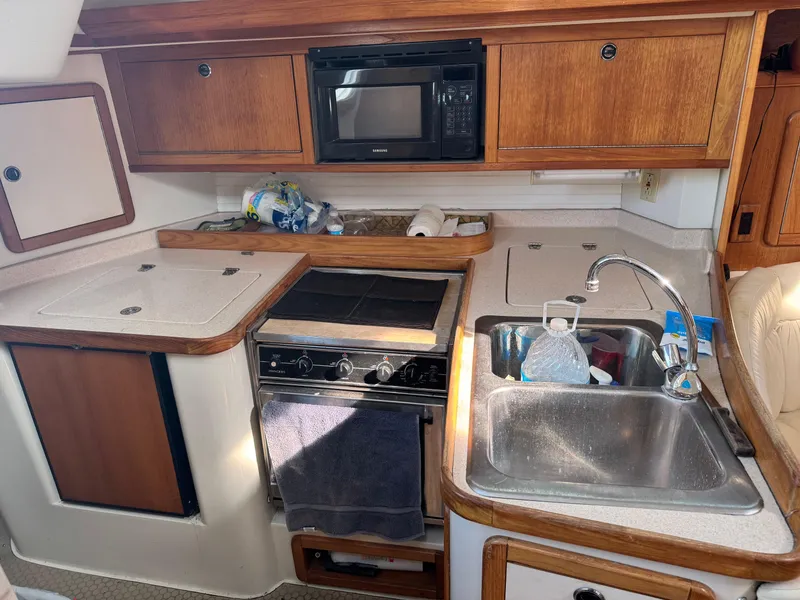 Slide: The Image of Compact kitchen in a 2001 Catalina 42 MK II sailboat with stove, sink, and microwave. - 24