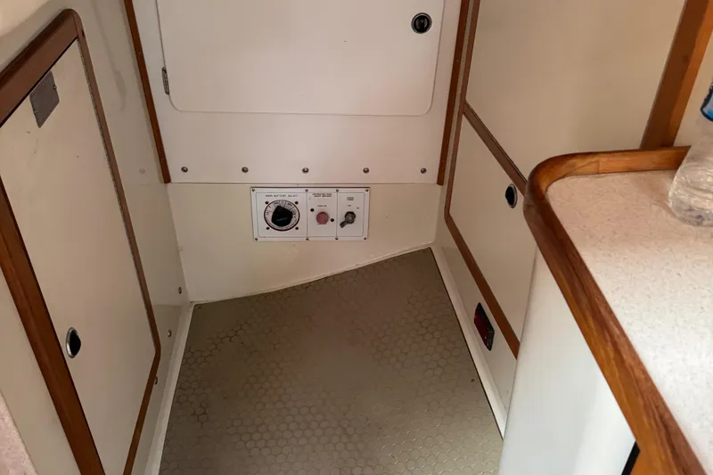 Slide: The Image of Interior of a 2001 Catalina 42 MK II sailboat, featuring cabinetry and control panel. - 27