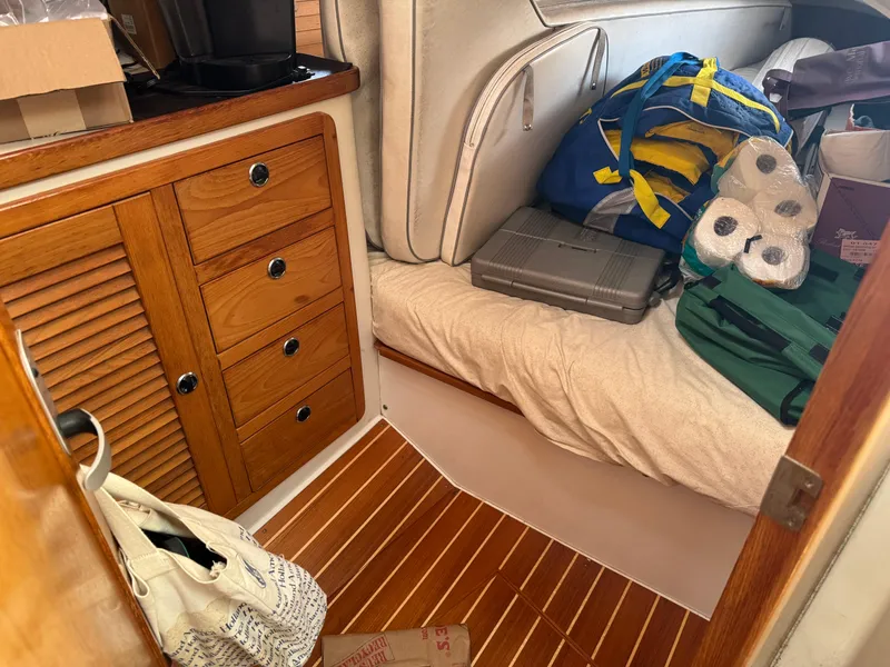 Slide: The Image of Cozy cabin interior of 2001 Catalina 42 MK II with wooden cabinetry and storage. - 28