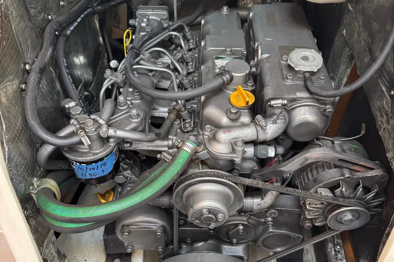 Slide: The Image of Engine of a 2001 Catalina 42 MK II sailboat, showcasing intricate components and hoses. - 29