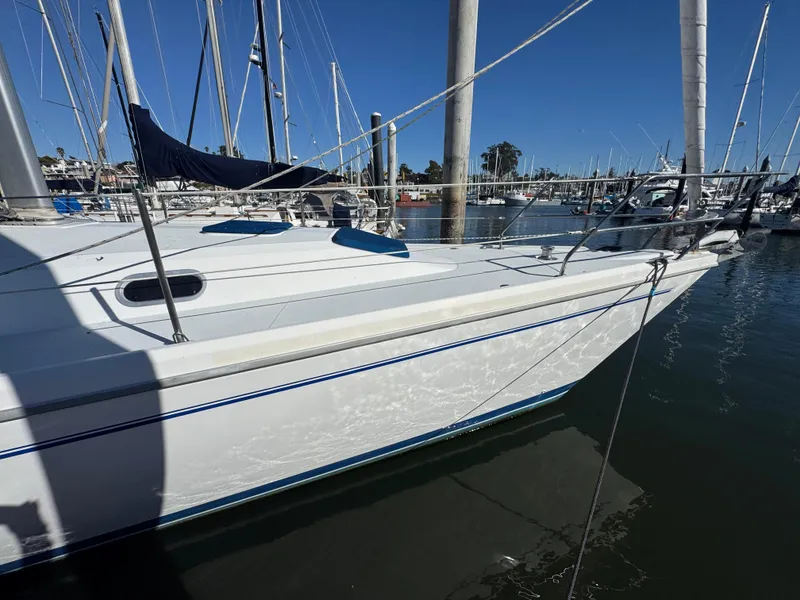 Slide: The Image of 2001 Catalina 42 MK II sailboat docked in a marina under clear blue skies. - 3